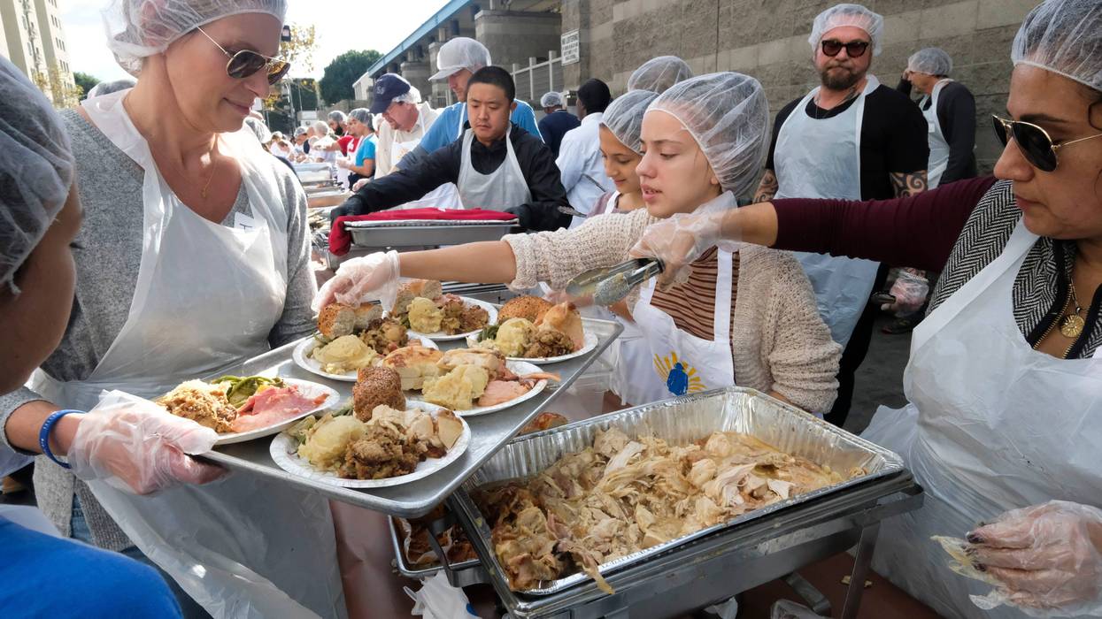 Servers dish out Thanksgiving foods for a charity meal in LA