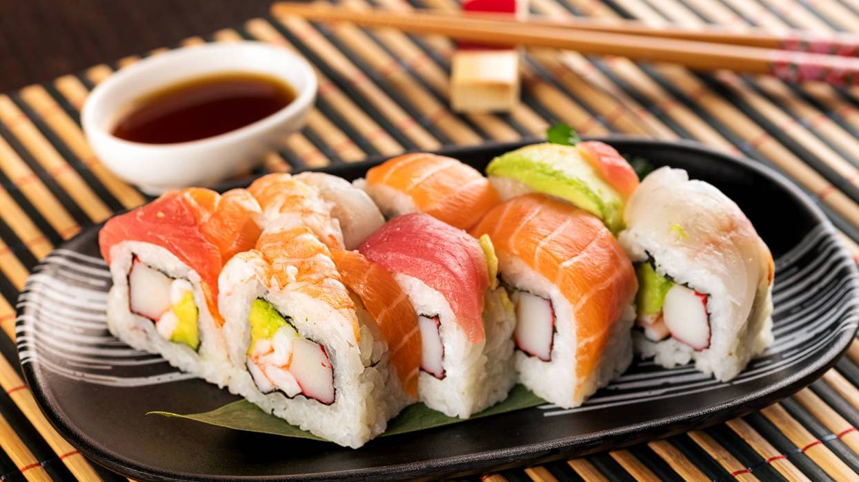 Set of rainbow uramaki sushi rolls with avocado