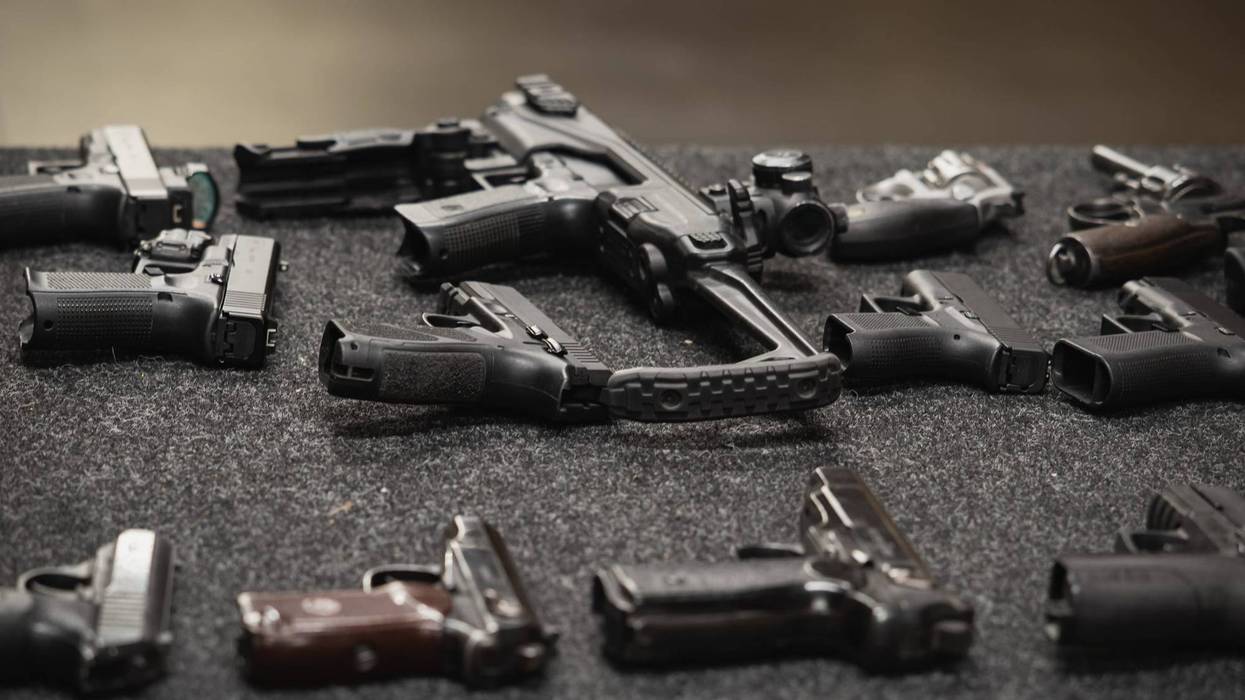 Several different firearms displayed on a table