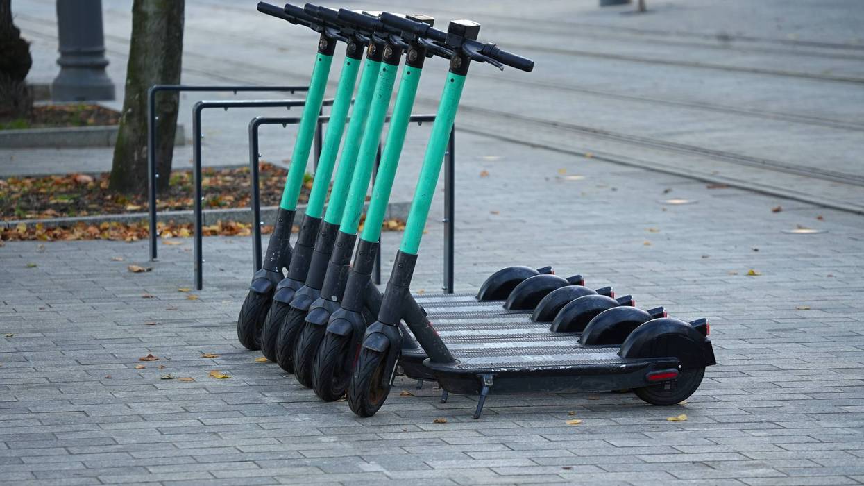 Several electric scooters parked in the city landscape