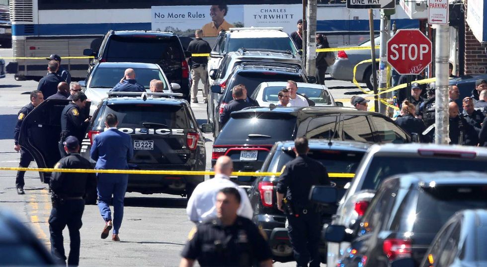 Several Yonkers police officers converge on the intersection of Elm Street and Linden Street in the Nodine Hill section of Yonkers, following a police involved shooting April 20, 2022.
