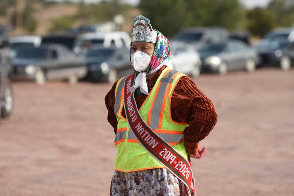 Shaandiin Parrish, Miss Navajo Nation, takes a brief pause while distributing food to Ganado community members