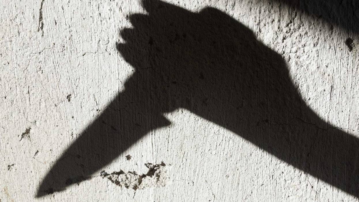 Shadow of hand with knife stock photo.