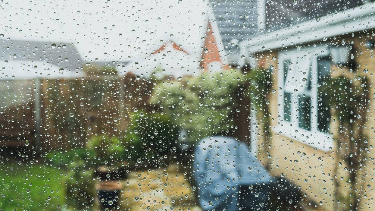 Shallow focus of raindrops seen on a conservatory window.