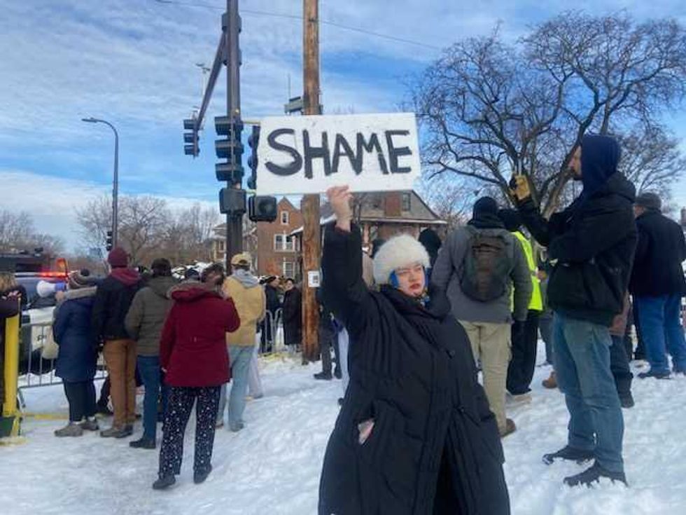 “Shame! Shame! Shame!” and “ICE out of Minnesota!” they loudly chanted from behind the police tape.