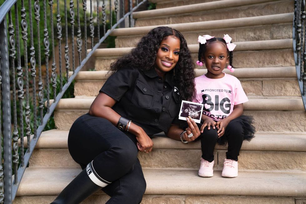 Shamea Morton and her daughter, Shya Mwangi together holding an ultrasound photo.