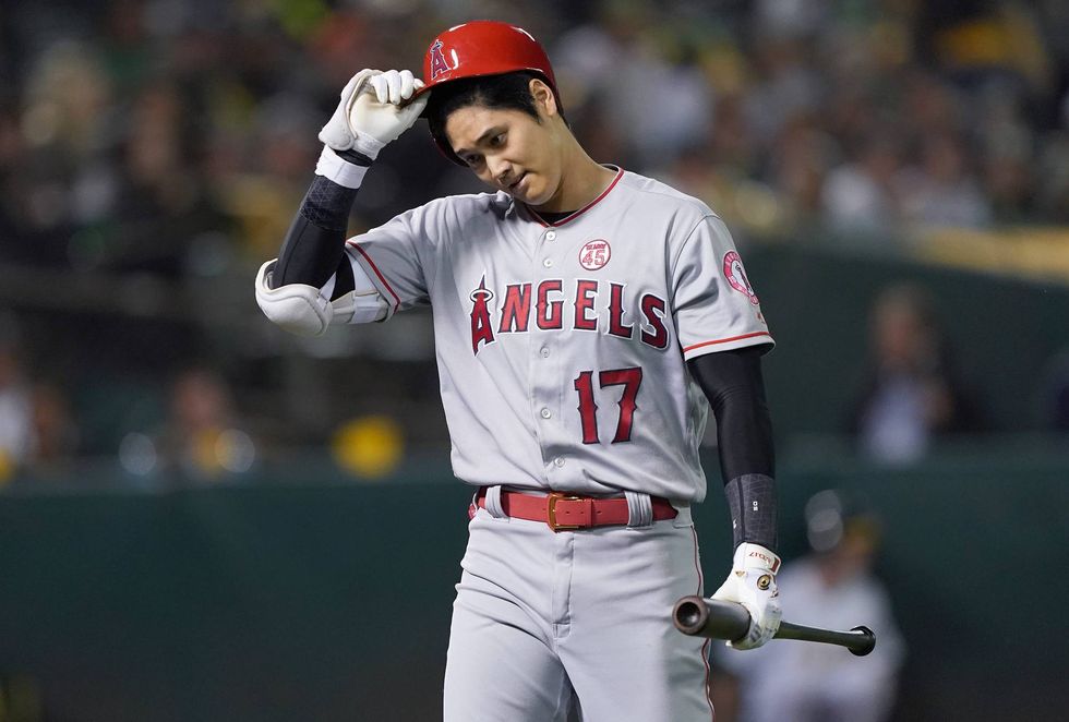 Shohei Ohtani returns to the dugout after making an out