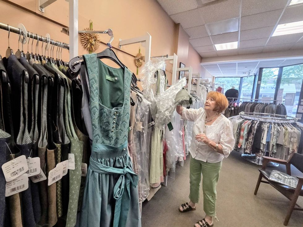 shop owner showing off dirndls