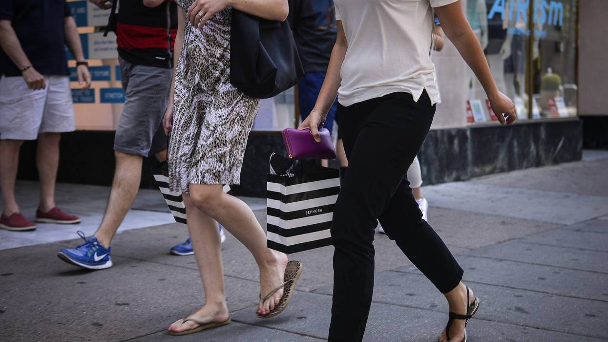 shopper carries a Sephora bag while walking in Center City