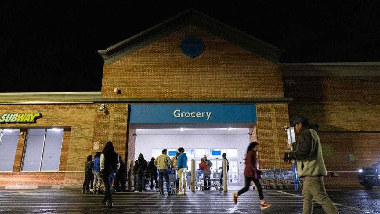 Shoppers lineup outside a Wal-Mart for Black Friday deals on November 25, 2022 in Dunwoody, Georgia. Walmart opened at 6am on Black Friday for shoppers. (Photo by Jessica McGowan/Getty Images)