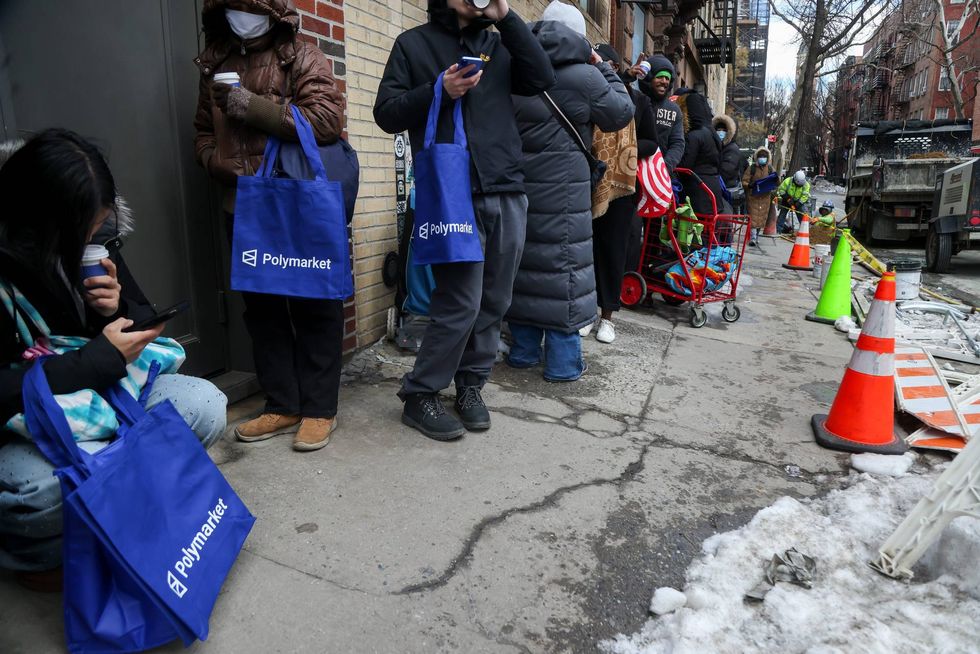 Shoppers wait in line during the opening of Polymarket