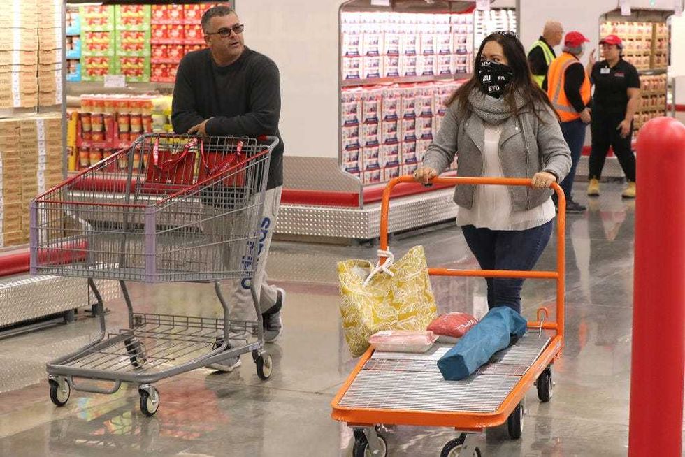 Shoppers walk down the aisles at Costco