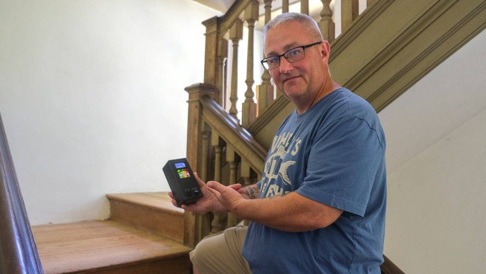 Shown above holding an electromagnetic field detector, John Levy founded Olde City Paranormal in 2009 and has been a member of the Philadelphia Police Department for nearly 25 years.
