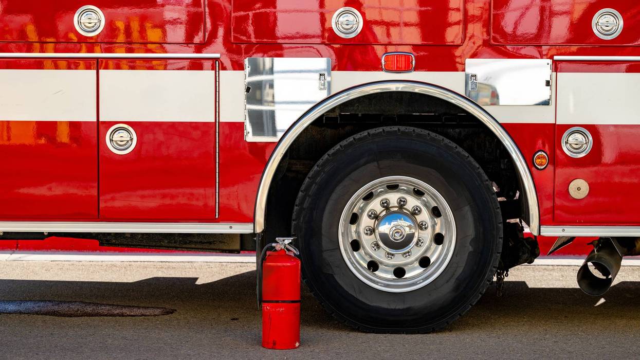 Side of a firetruck with fire extinguisher