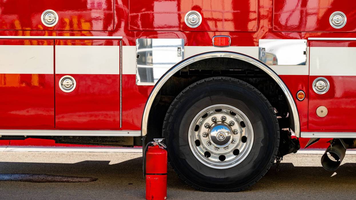 Side of a firetruck with fire extinguisher