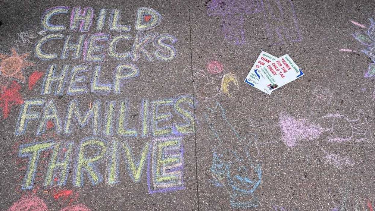 Sidewalk chalk drawings done by parents and children to celebrate new monthly Child Tax Credit payments and urge congress to make them permanent outside Senator Schumer's home on July 12, 2021 in Brooklyn, New York.