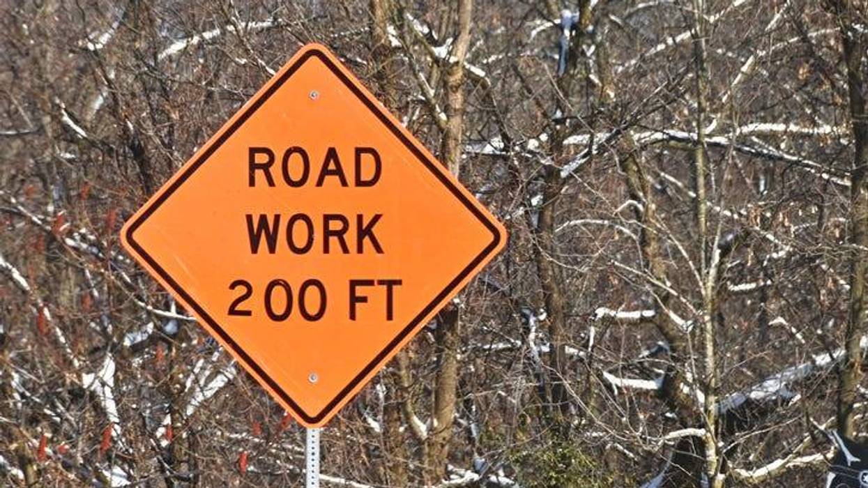 sign says road work in 200 ft.