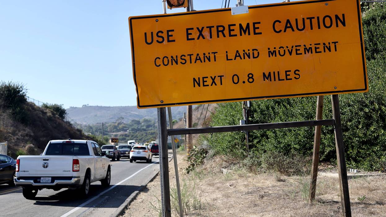 sign that says use extreme caution constant land movement next 0.8 miles