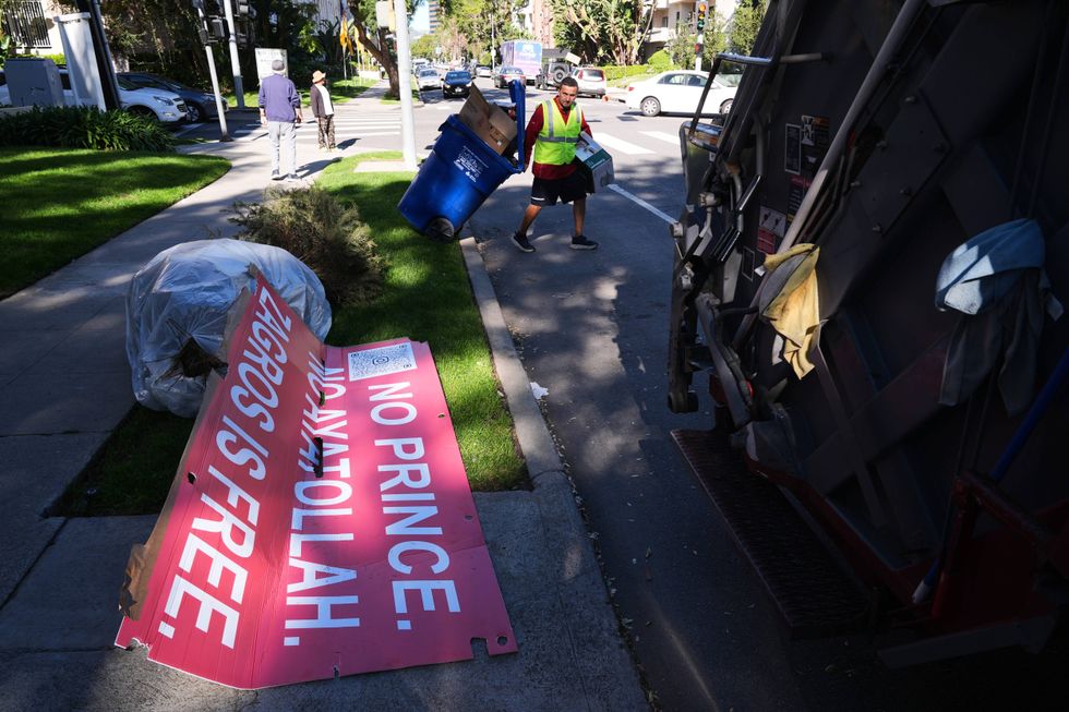 Signs from a Sunday protest, supporting protesters in Iran, are left on a sidewalk Monday, Jan. 12, 2026, in Los Angeles.
