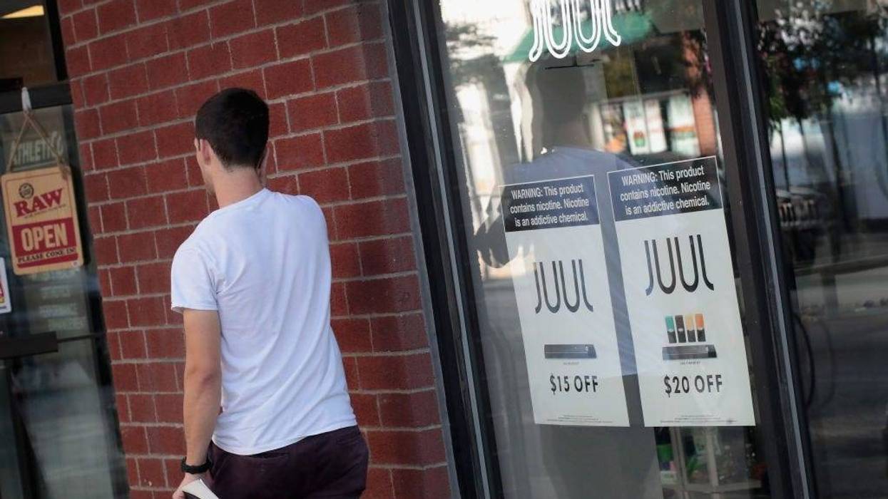 Signs in the window of the Smoke Depot advertise electronic cigarettes and pods by Juul, the nation's largest maker of e-cigarette products, on September 13, 2018 in Chicago, Illinois.