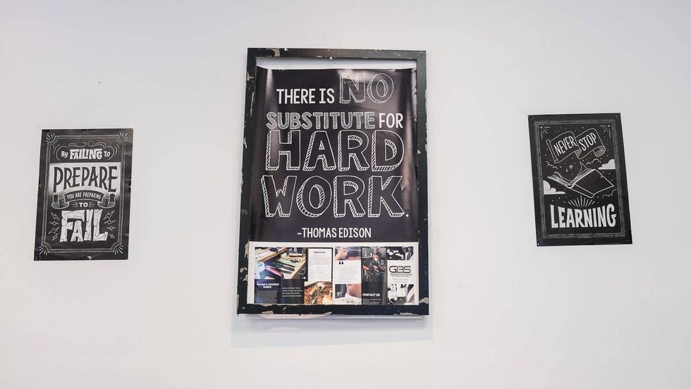 Signs inside Generations Barber Academy.