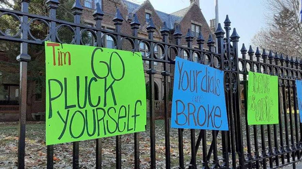 Signs on fence in front of governor's residence