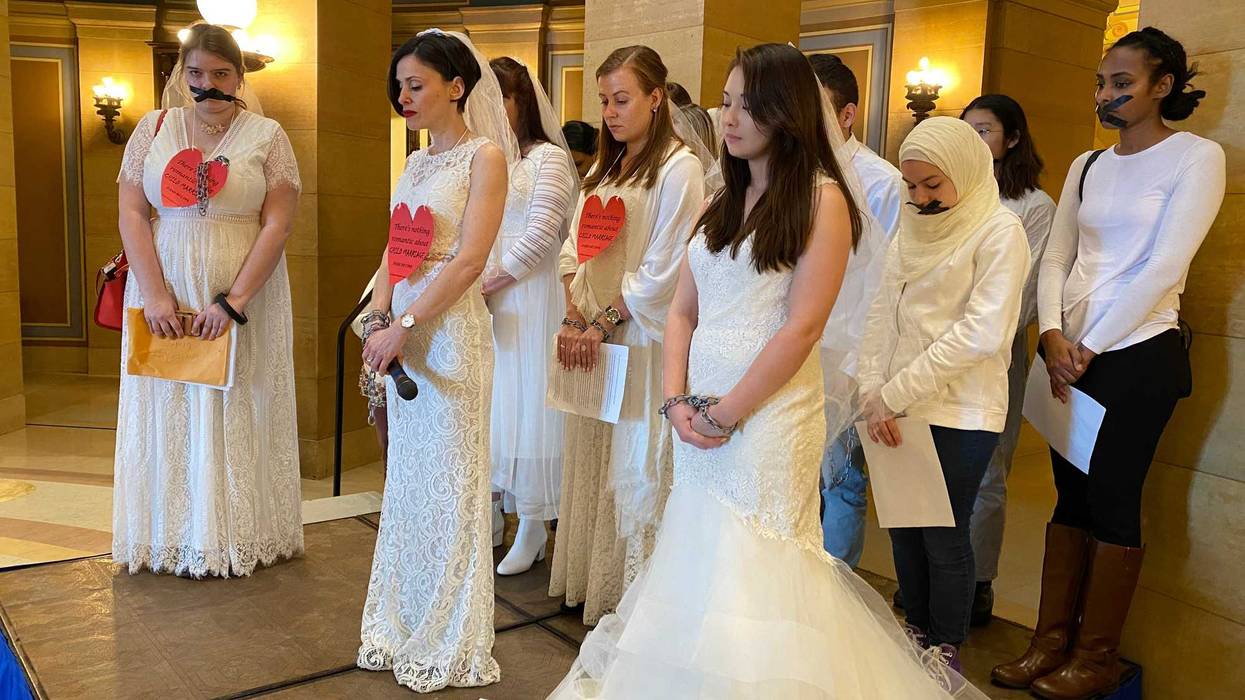 Signs read "There's nothing romantic about child marriage"