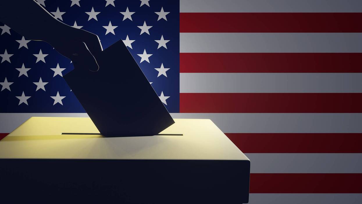 Silhouette of a hand holding a vote putting in a ballot box in front of the national flag Stars and Stripes of USA. Illustration of the concept of the United States general election
