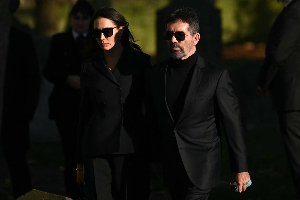 Simon Cowell (R) and Lauren Silverman leave after attending the funeral service of the late One Direction singer Liam Payne