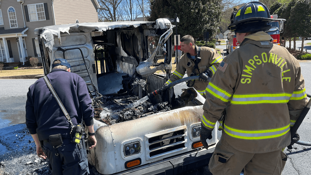 Simpsonville fire personnel finish controlling the fire that erupted from a mail truck