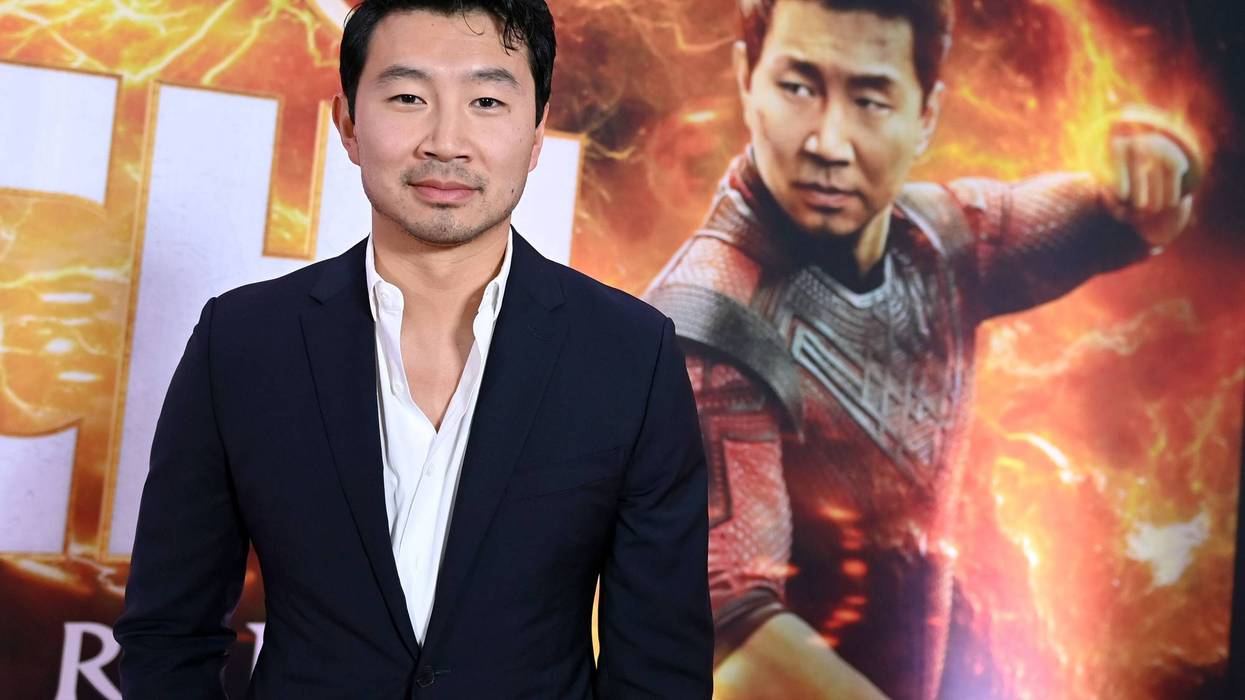 Simu Liu in front of a "Shang-Chi" display at the film's Toronto premiere.