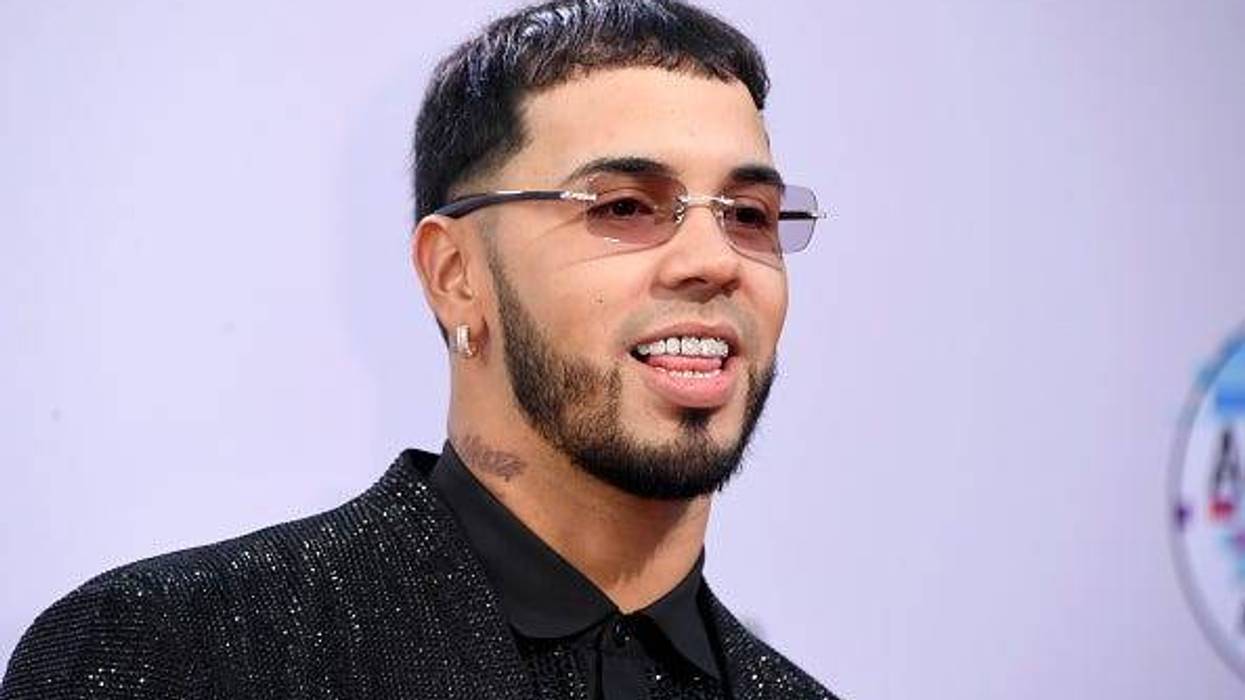 singer Anuel AA smiling wearing dimonds on his teeth