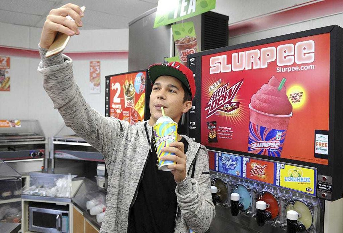 Singer Austin Mahone takes a selfie and enjoys a Slurpee during 7-Eleven's kickoff for Slurpee All Access Chill on May 6, 2015 in Boca Raton, Florida. (Photo by Larry Marano/Getty Images for 7-Eleven)