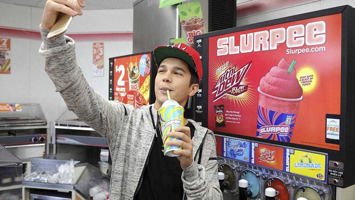 Singer Austin Mahone takes a selfie and enjoys a Slurpee during 7-Eleven's kickoff for Slurpee All Access Chill on May 6, 2015 in Boca Raton, Florida. (Photo by Larry Marano/Getty Images for 7-Eleven)