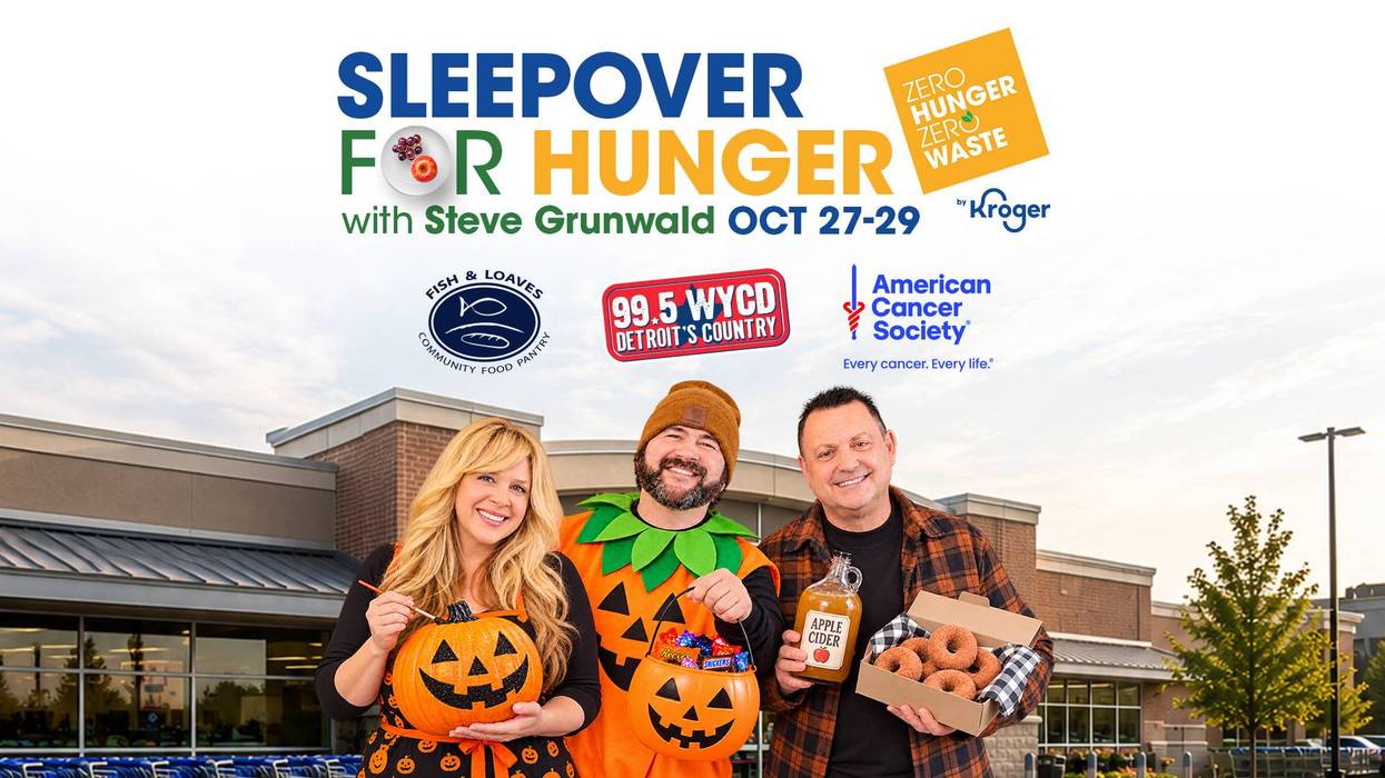 Sleepover for Hunger event: 3 smiling people in Halloween outfits with donuts & pumpkins.