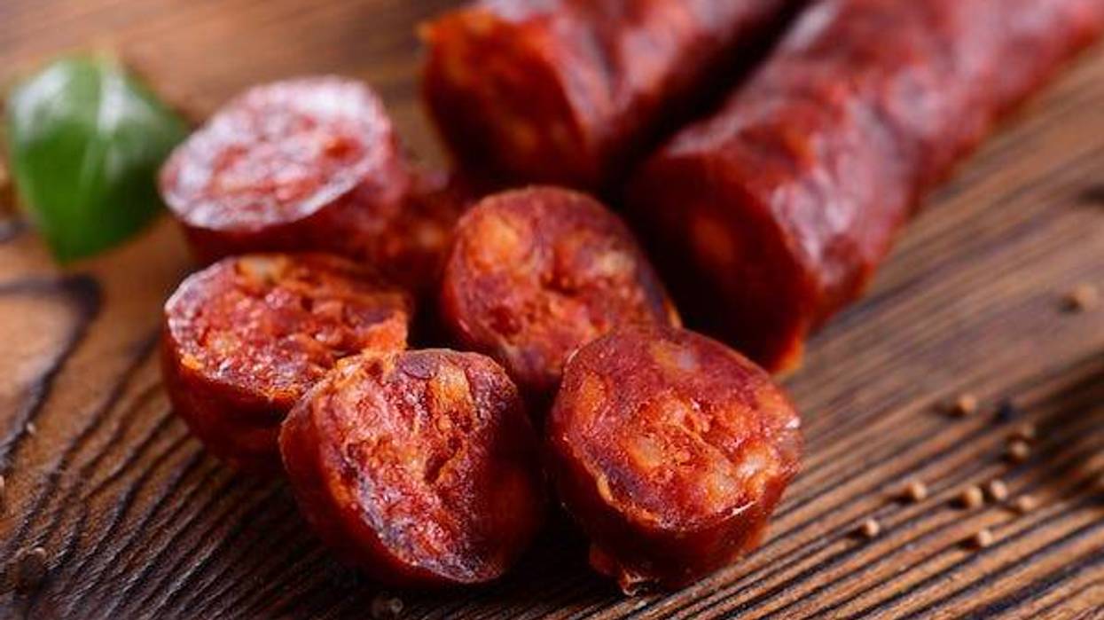 Sliced chorizo on wooden board
