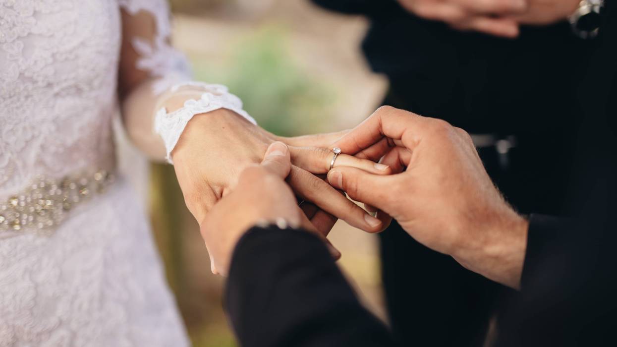 Sliding wedding ring on hand