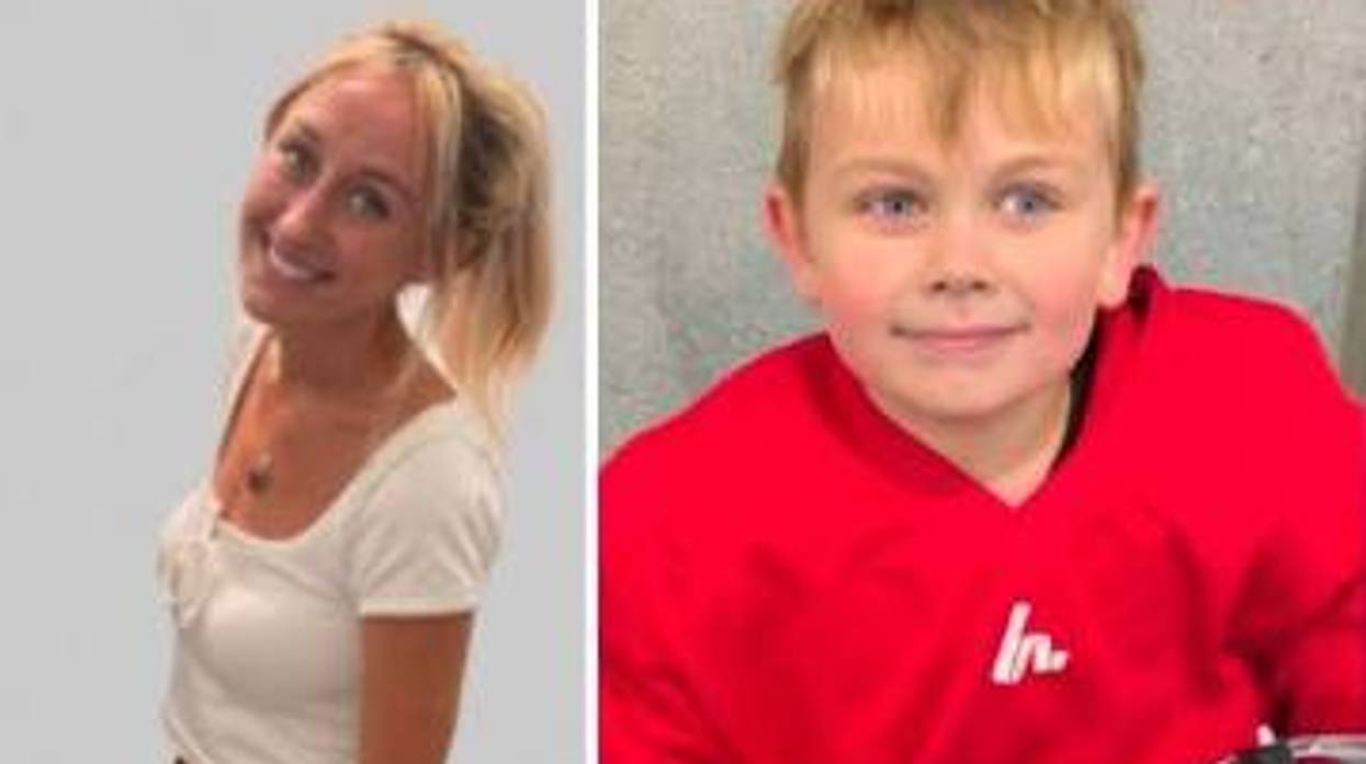 Smiling blonde woman in white top on left, blonde boy in red shirt on right.