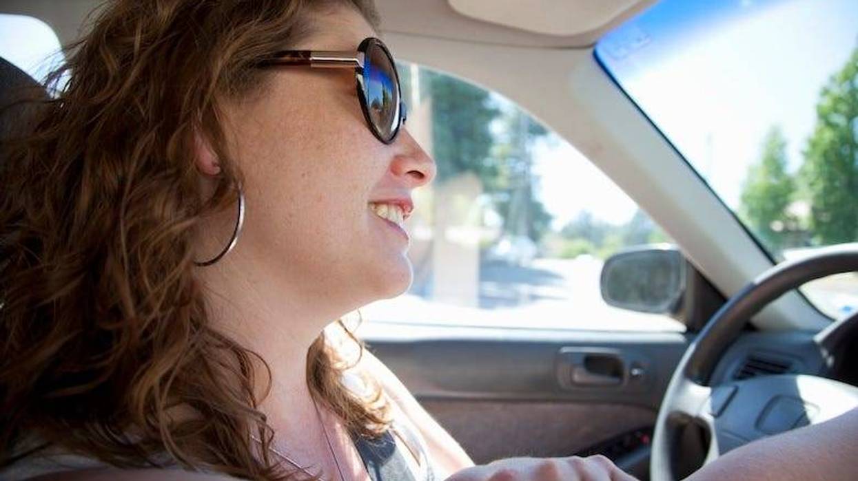 Smiling woman driving car