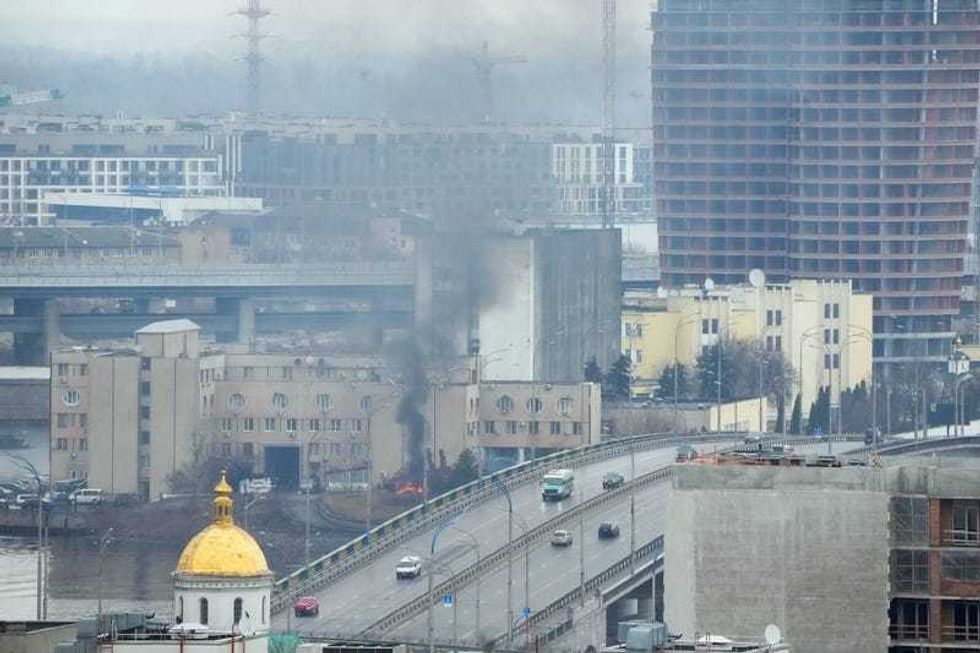 Smoke and flame rise near a military building after an apparent Russian strike in Kyiv, Ukraine, Thursday, Feb. 24, 2022