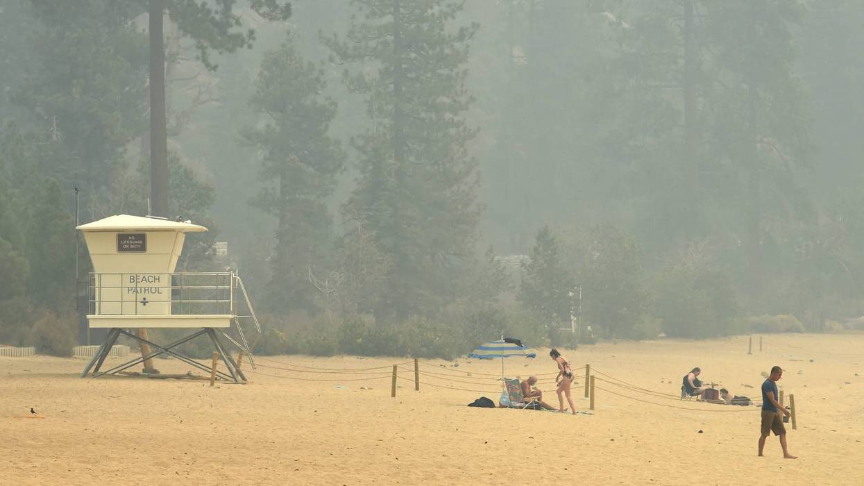 Smoke did not stop some people from visiting Lake Tahoe at Sand Harbor Beach in Washoe County, Nev., on Aug. 24, 2021.