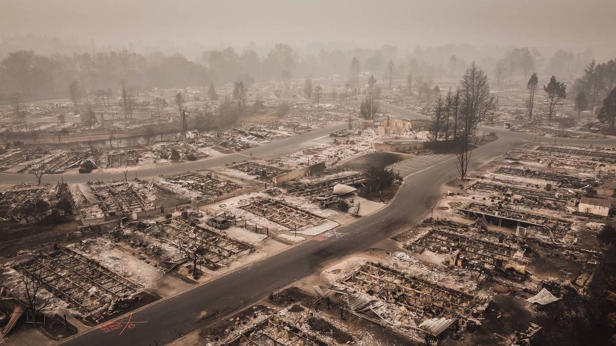 Smoke filled skies overlooking the aftermath and tragedy of a wildfire that blew through small town