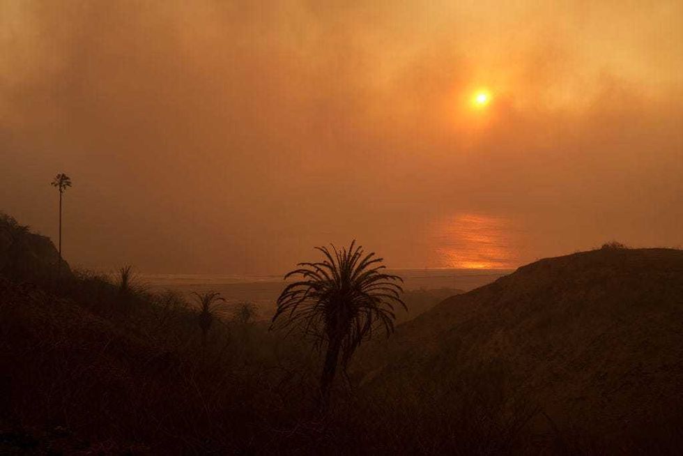Smoke from the Palisades Fire is seen over the Pacific Ocean on January 8, 2025 in the Pacific Palisades neighborhood of Los Angeles, California. Multiple wildfires fueled by intense Santa Ana Winds are burning across Los Angeles County. Five people have been killed, over 25,000 acres have burned, and 30,000 people have been evacuated.
