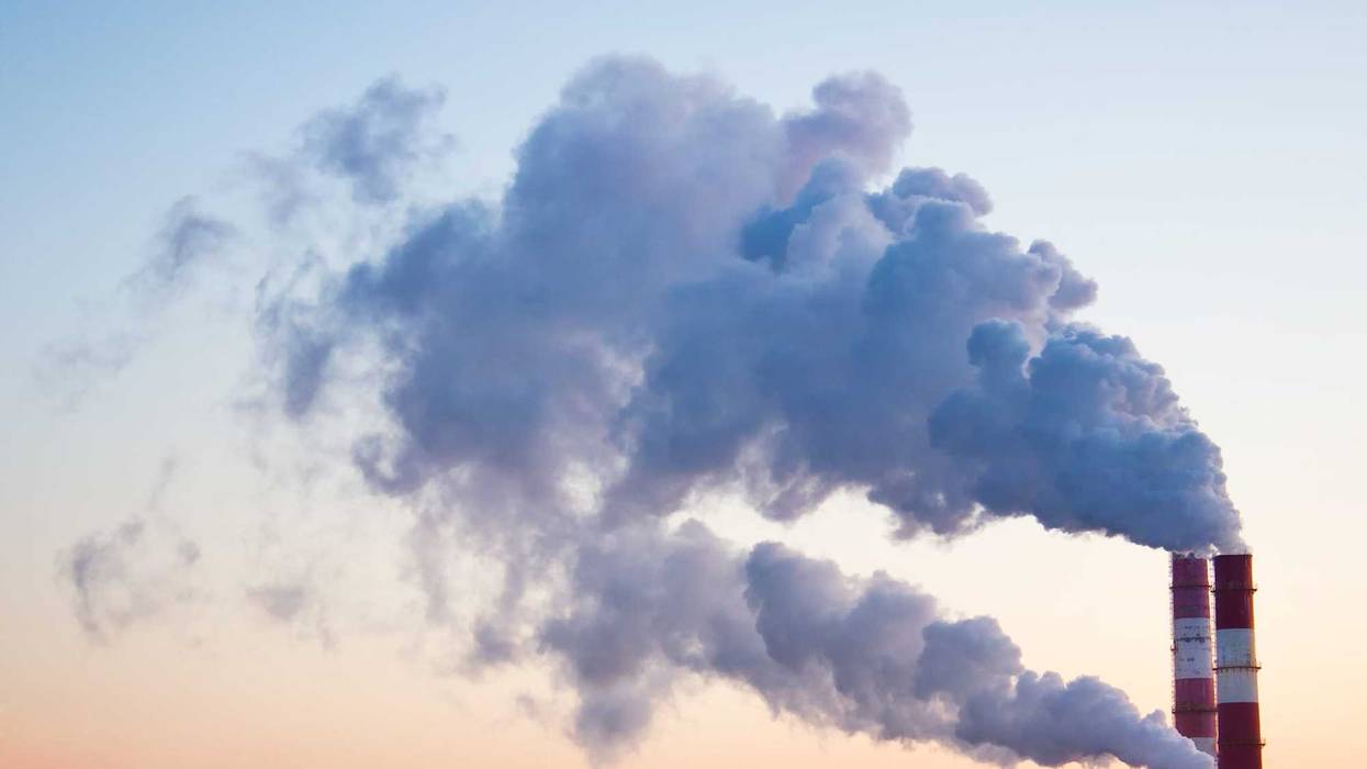 Smoke, fumes coming out of pipes of factory producing heat for central heating.