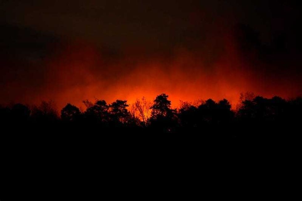 Smoke rises from a wildfire early Wednesday, April 23, 2025, near Barnegat Township, N.J