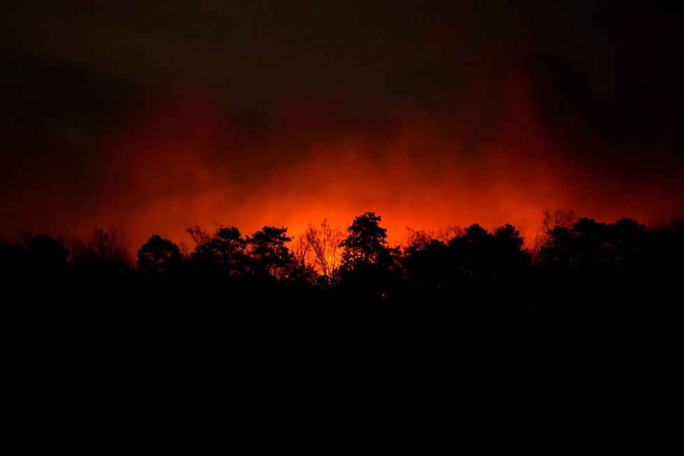 Smoke rises from a wildfire early Wednesday, April 23, 2025, near Barnegat Township, N.J.