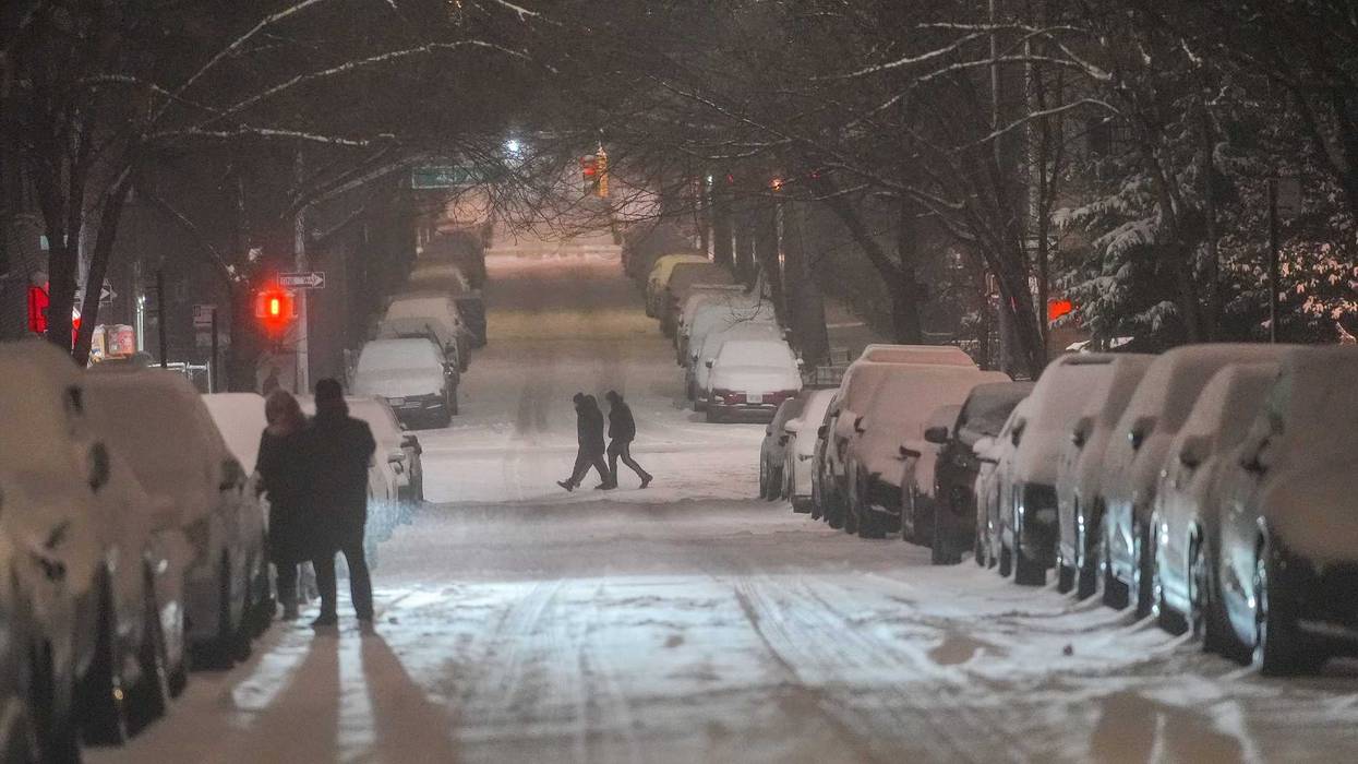 Snow-covered cars line the streets as a winter storm brings heavy snowfall to New York City on Feb. 8, 2025
