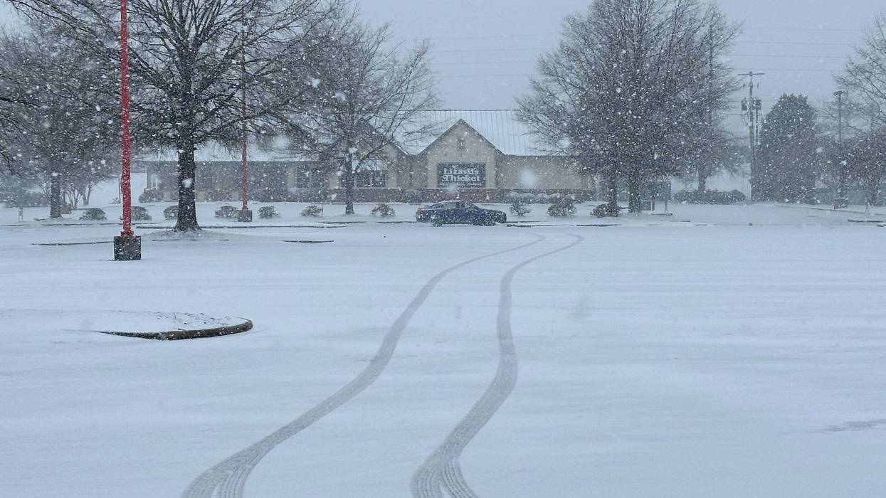Snow falls outside a shopping center in Columbia, S.C., on Saturday, Jan. 31, 2026.