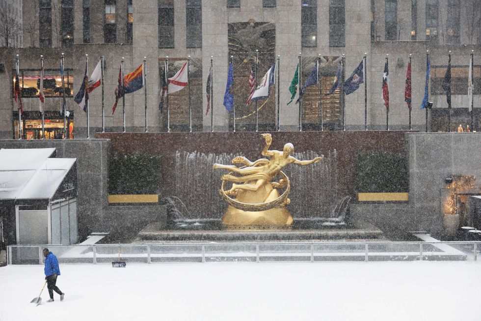 Snow is cleared off the ice rink at Rockefeller Center amid a winter storm on February 13, 2024