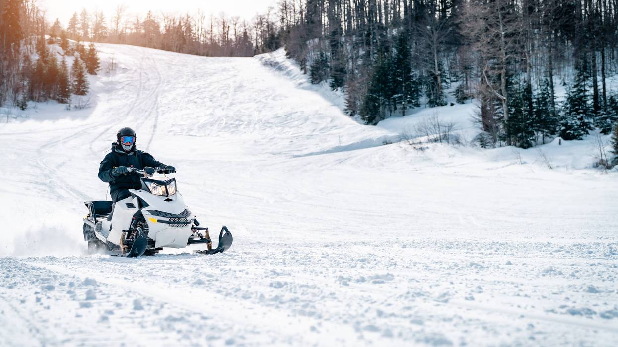Snowmobiler on snowy trail